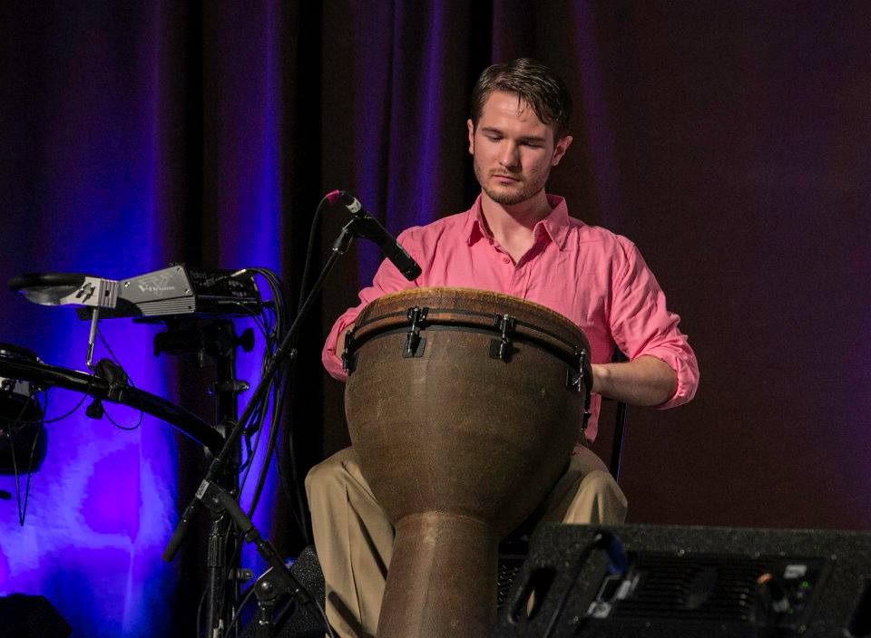 Chris Ulery playing djembe during worship