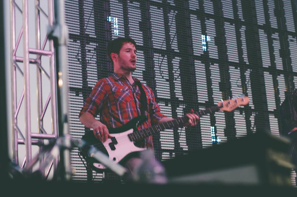 Chris Ulery playing bass on an outdoor festival stage