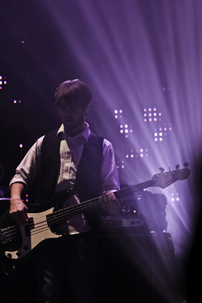 Chris Ulery playing bass in purple stage light