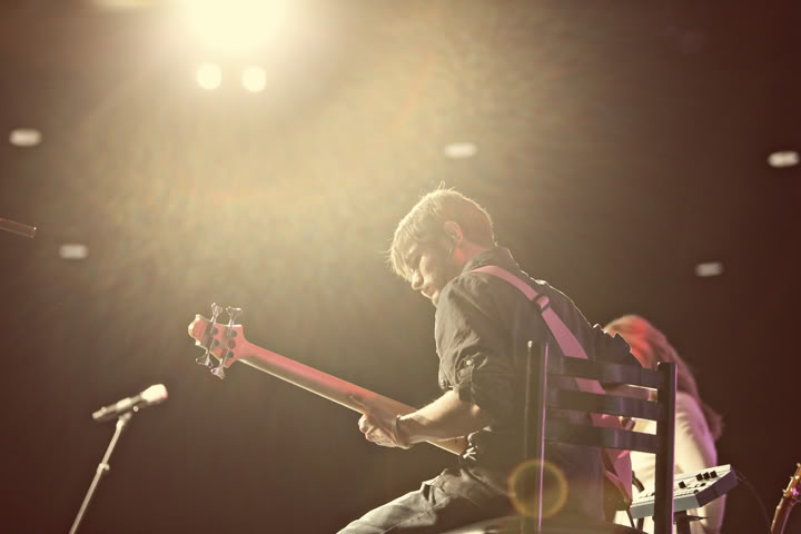 Chris Ulery playing bass in a warm spotlight