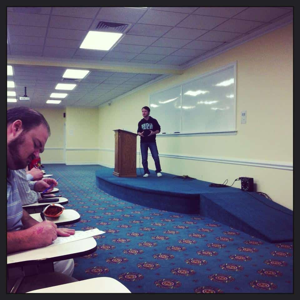 Chris Ulery lecturing in a classroom as students take notes