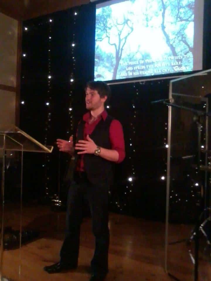Chris Ulery preaching at an evening church service