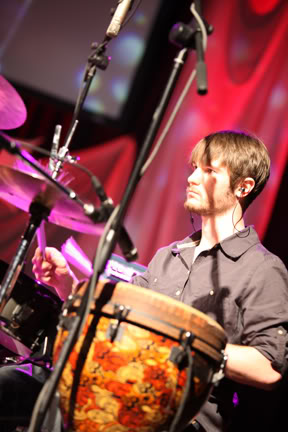 Chris Ulery playing hand percussion during worship