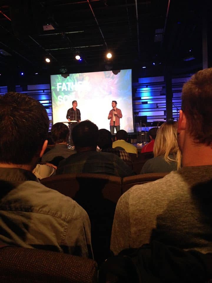 Chris Ulery speaking at an IIID Young Adults service at Victory Church, seen from the audience