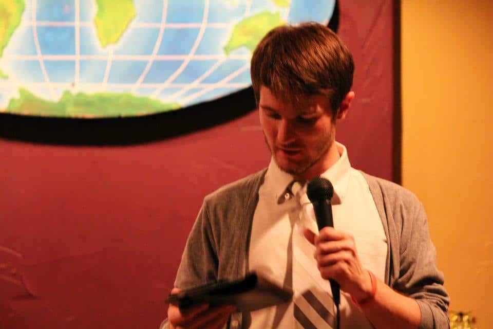 Chris Ulery looking down at his notes while speaking into a microphone