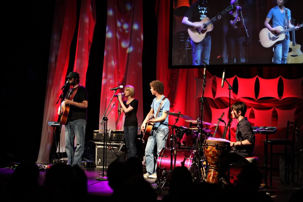 Chris Ulery performing with NewFire on a red-lit stage
