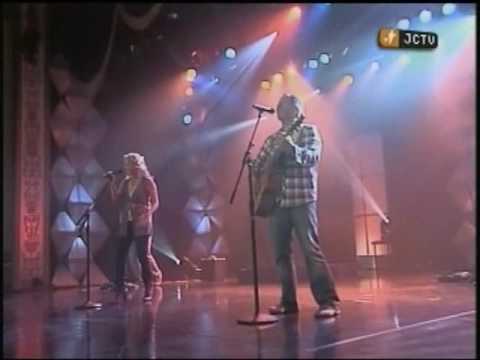 Chris Ulery playing acoustic guitar and singing on 1 Music Village