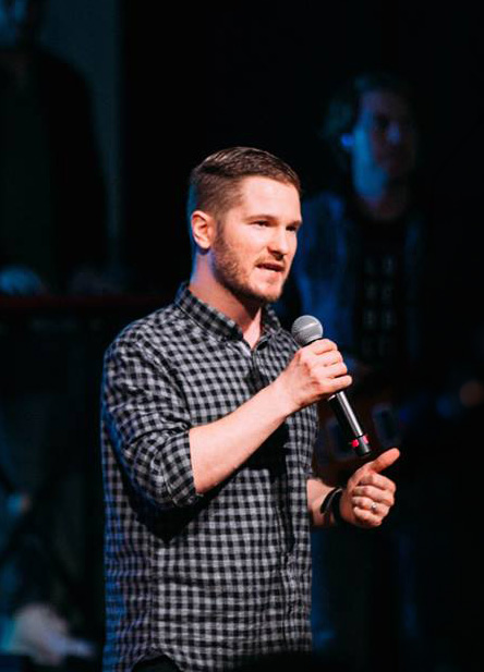 Chris Ulery preaching in a plaid shirt at Victory Downtown in Tulsa