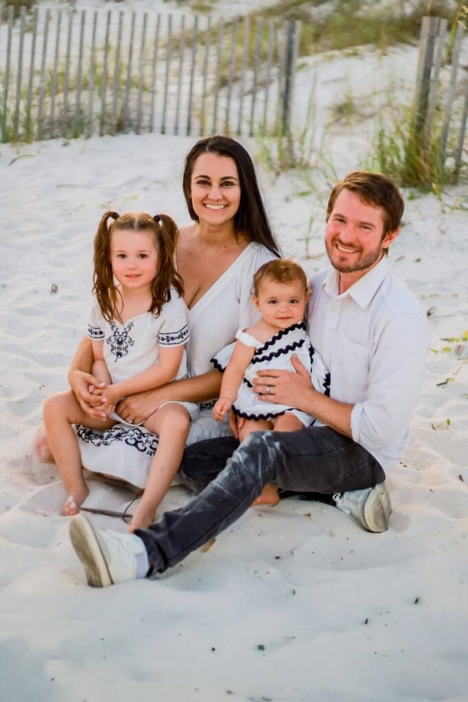 Chris and Jessica Ulery with their two children on the beach